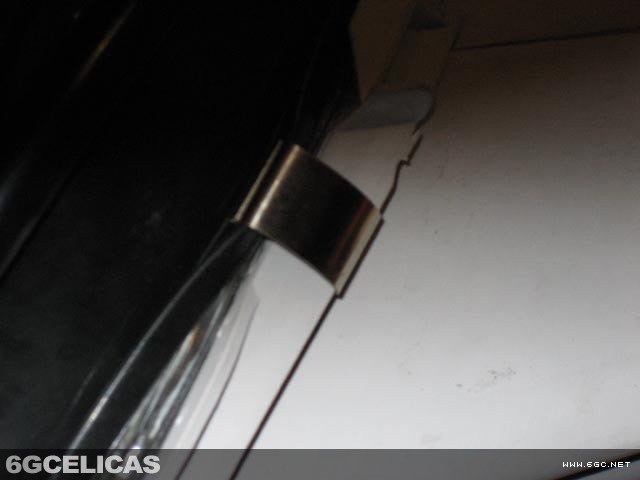 JDM projector headlight with metal clips visible